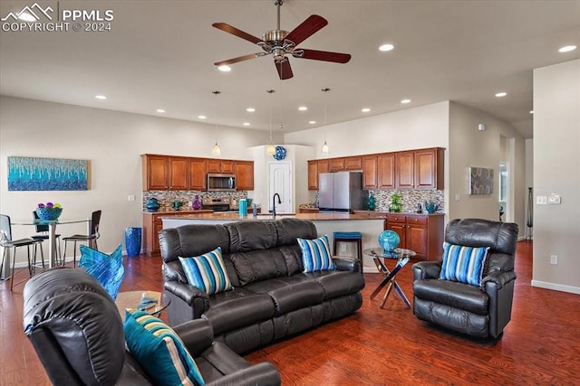 living room featuring dark hardwood / wood-style flooring, ceiling fan, and sink