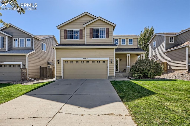 view of front of home featuring a front yard and a garage