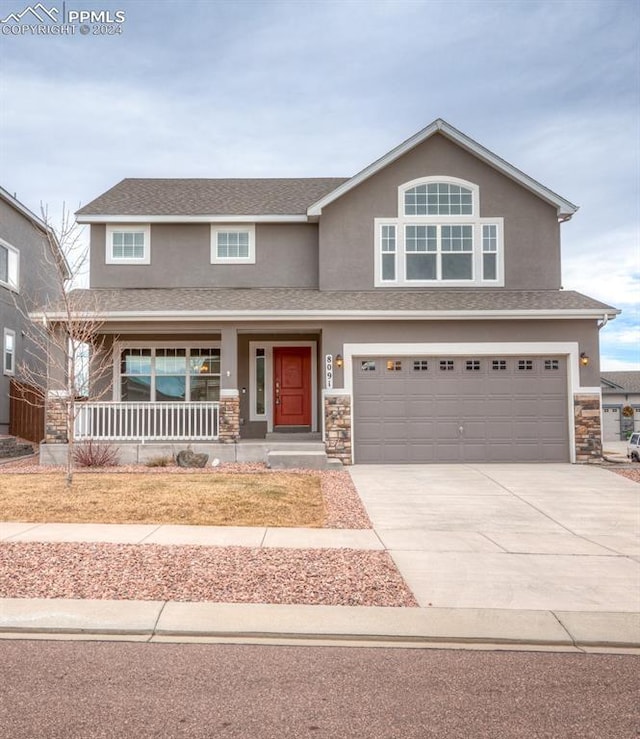 view of front of home with a porch and a garage