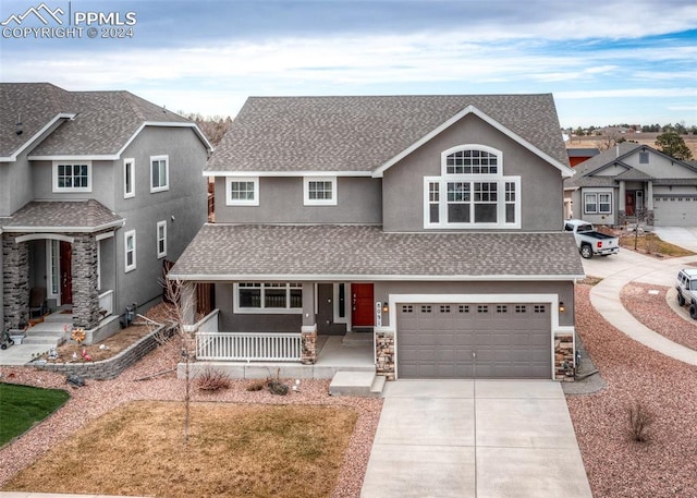 view of front of home with covered porch and a garage