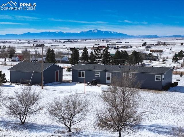 snowy aerial view with a mountain view