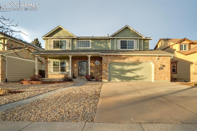 view of front of property with covered porch and a garage