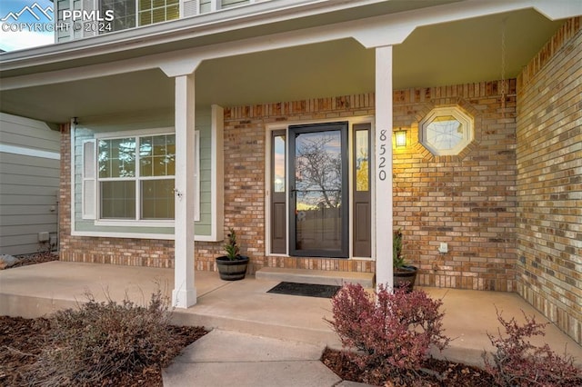 view of exterior entry with covered porch