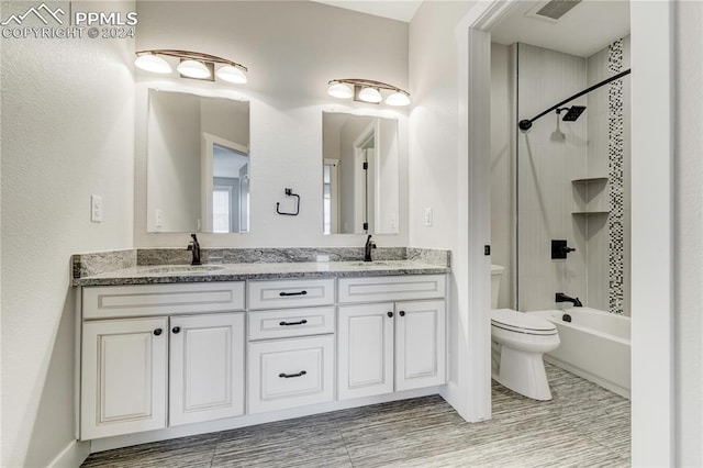 full bathroom featuring toilet, vanity, and bathing tub / shower combination