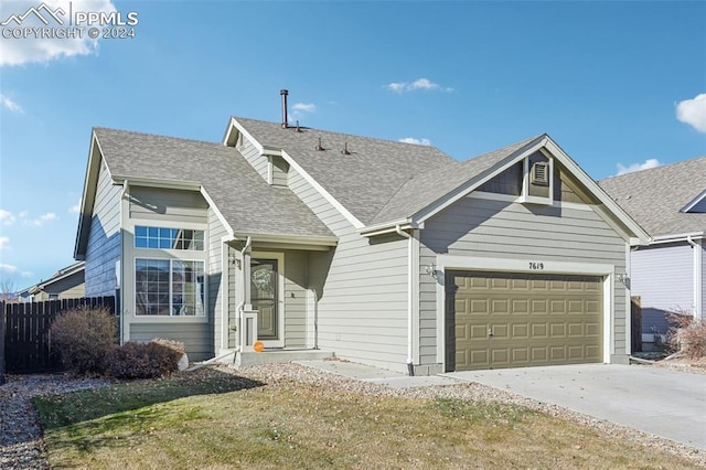 view of front of property featuring a front yard and a garage