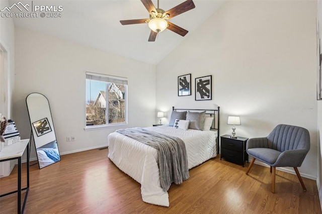 bedroom with ceiling fan, high vaulted ceiling, and wood-type flooring