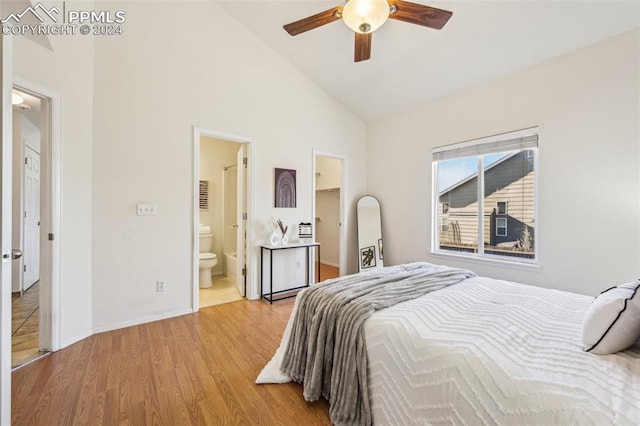 bedroom featuring high vaulted ceiling, ceiling fan, light wood-type flooring, and connected bathroom