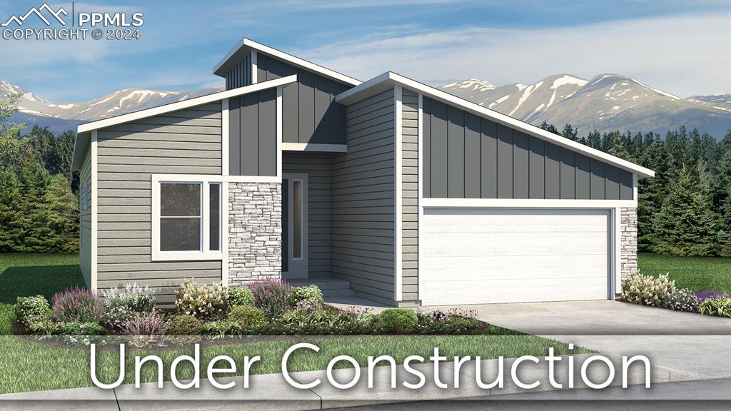 view of front of home featuring a mountain view and a garage