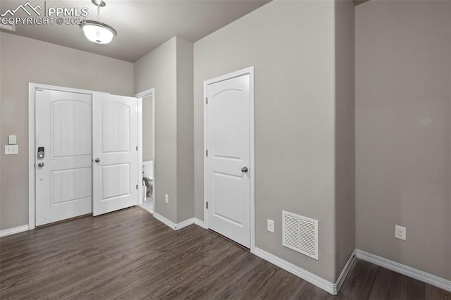 entryway with dark hardwood / wood-style flooring