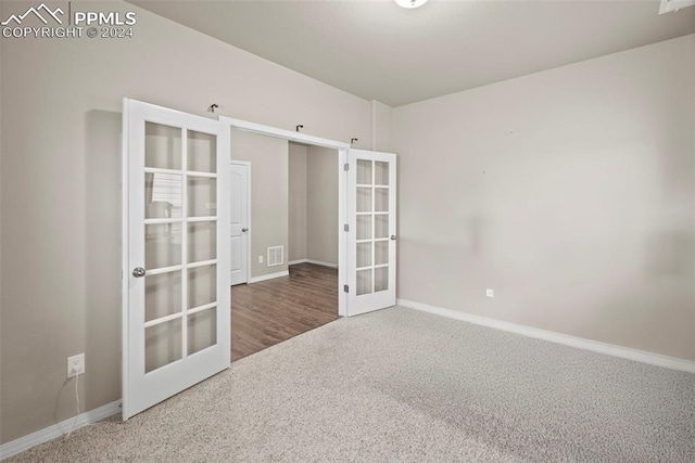 spare room with carpet flooring and french doors