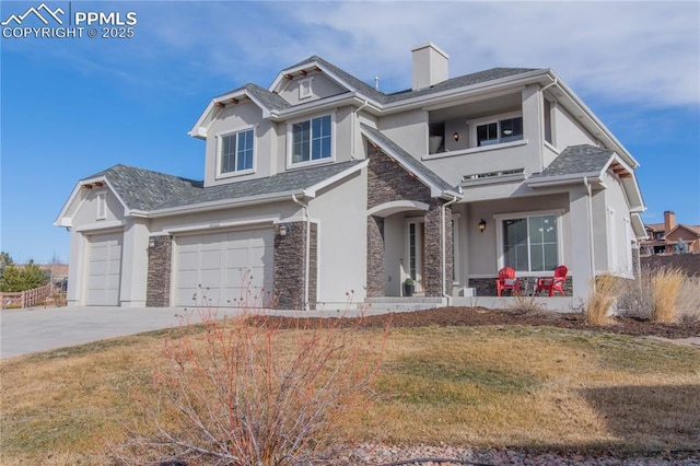 view of front of property featuring a front yard and a garage