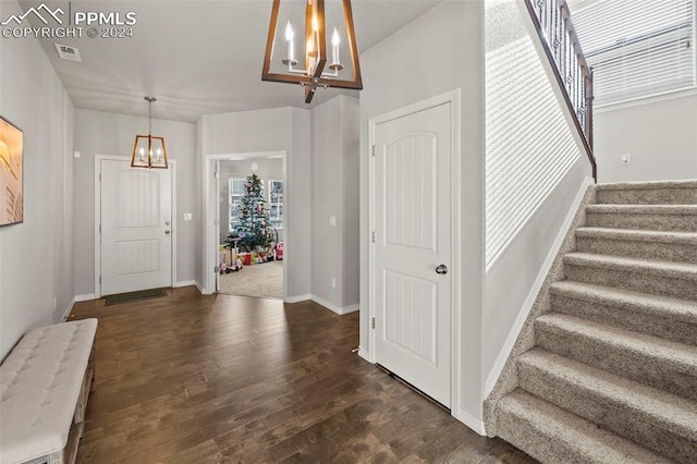 foyer featuring a notable chandelier and dark hardwood / wood-style flooring