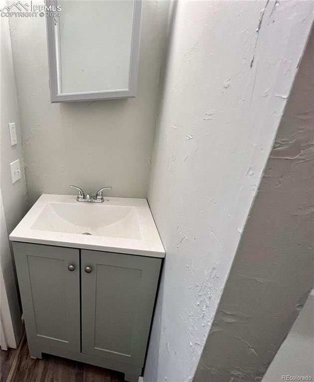 bathroom featuring hardwood / wood-style flooring and vanity