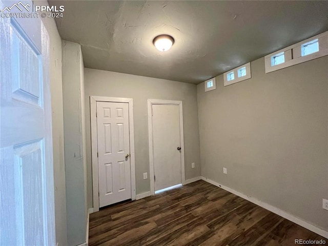 interior space featuring dark hardwood / wood-style flooring and two closets