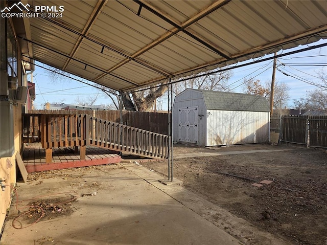 view of patio with a shed and a deck