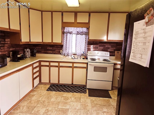 kitchen featuring refrigerator, white electric range, sink, and tasteful backsplash