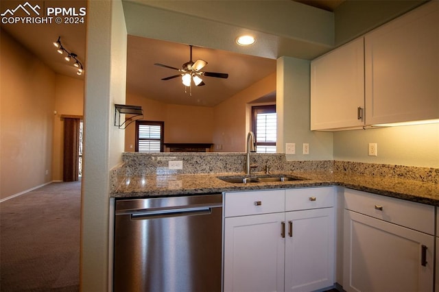 kitchen with dishwasher, sink, ceiling fan, stone countertops, and white cabinetry