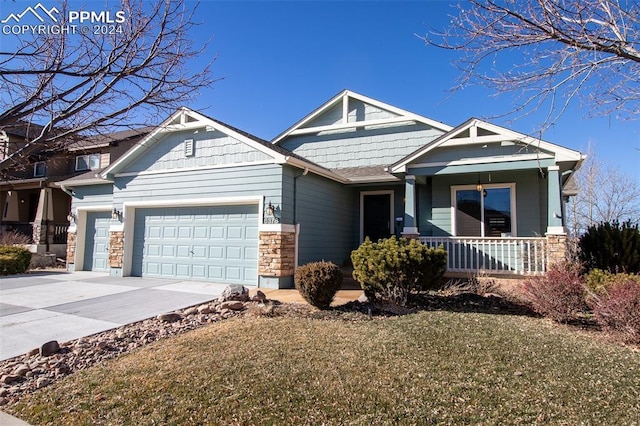 craftsman-style home with a porch and a garage