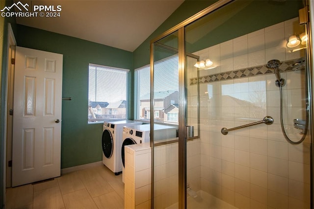 clothes washing area featuring separate washer and dryer and light tile patterned floors