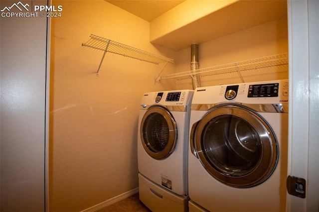 laundry room with washing machine and clothes dryer