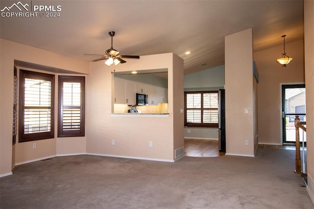 unfurnished living room with carpet, ceiling fan, and lofted ceiling