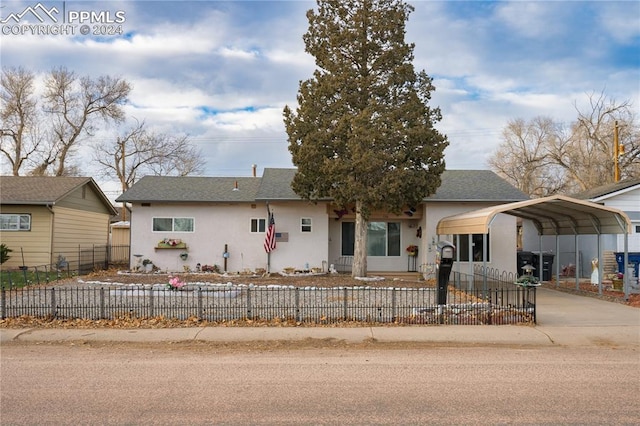 single story home featuring a carport