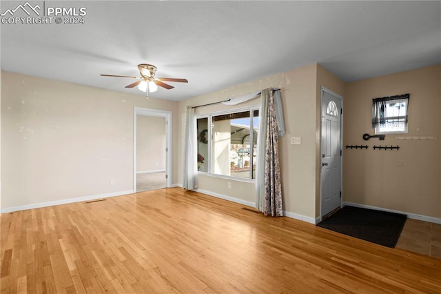 foyer entrance featuring ceiling fan, a healthy amount of sunlight, and light hardwood / wood-style floors