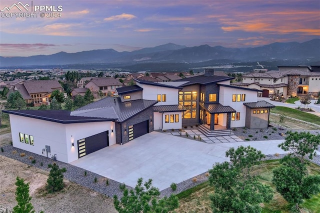 view of front of property featuring a mountain view and a garage