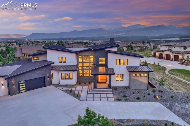 view of front of home with a mountain view and a garage