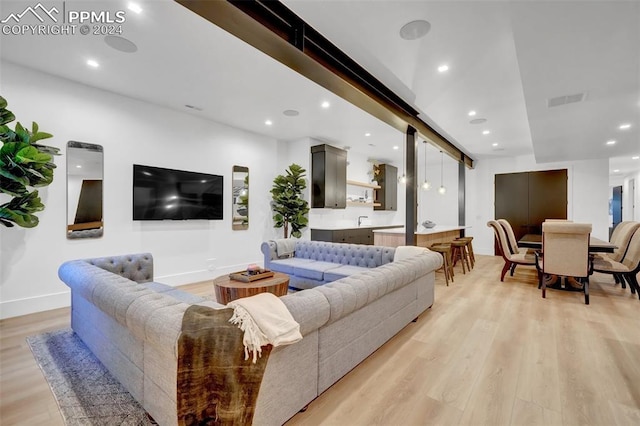 living room with sink and light wood-type flooring