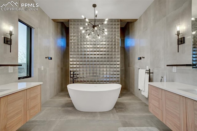 bathroom featuring a bathtub, concrete flooring, tile walls, and a chandelier