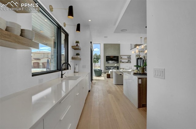 hallway featuring light hardwood / wood-style flooring and sink