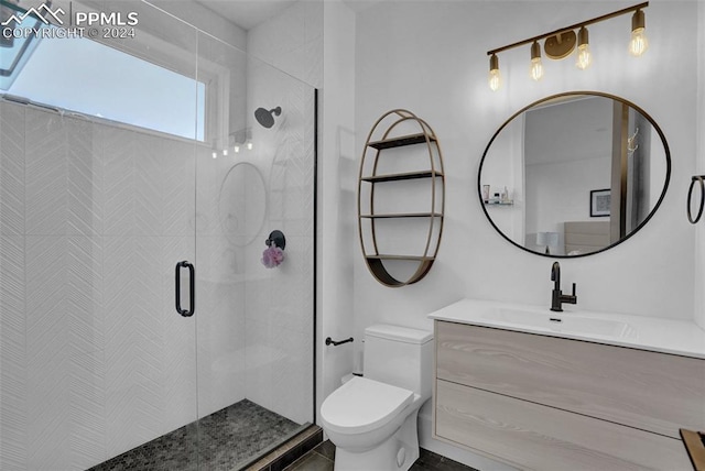 bathroom with vanity, toilet, and a shower with door