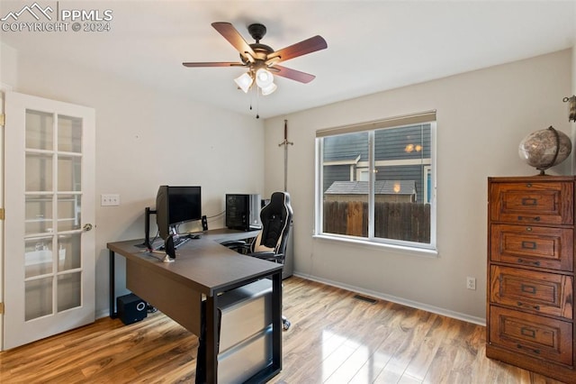 office space with ceiling fan and light hardwood / wood-style floors