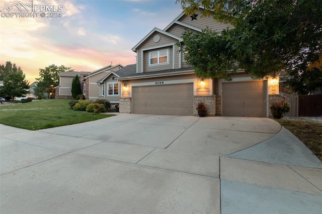 craftsman house with a lawn and a garage