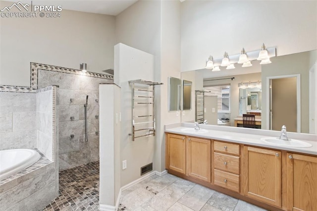 bathroom with shower with separate bathtub and vanity