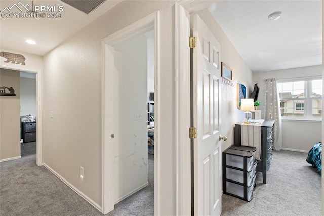 corridor with light colored carpet