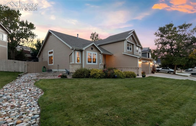 view of front of house with a lawn and a garage