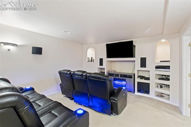 cinema room featuring light carpet and built in features