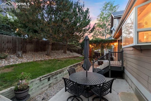 view of patio terrace at dusk