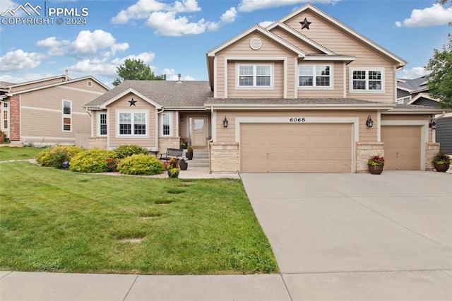 view of front of home featuring a garage and a front lawn