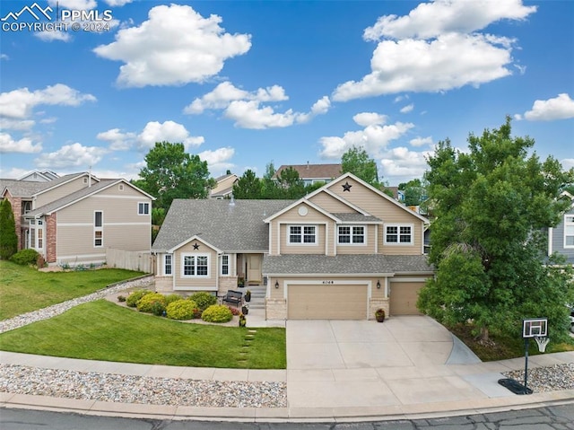 view of front of house with a garage and a front lawn