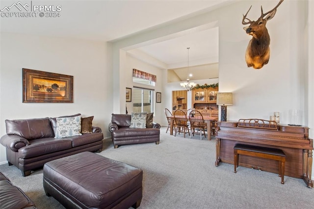 carpeted living room featuring an inviting chandelier