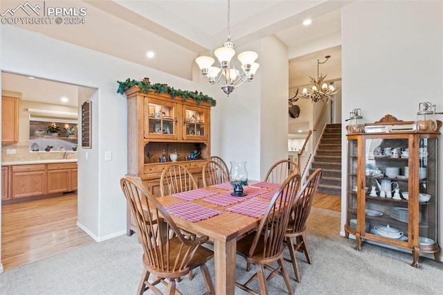 dining area with a chandelier and light hardwood / wood-style floors