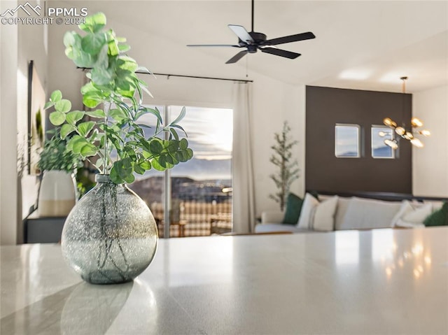 details featuring ceiling fan with notable chandelier