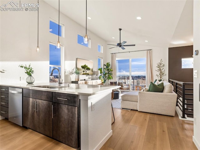 kitchen with sink, decorative light fixtures, light hardwood / wood-style flooring, ceiling fan, and dark brown cabinets