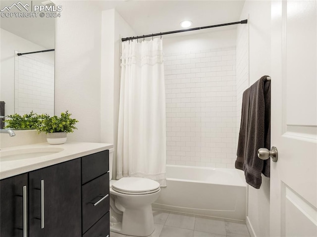 full bathroom featuring tile patterned flooring, shower / bath combination with curtain, vanity, and toilet