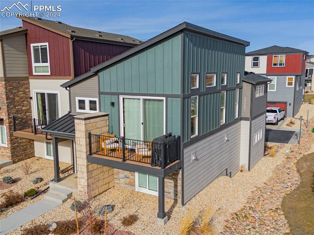 rear view of property with a balcony