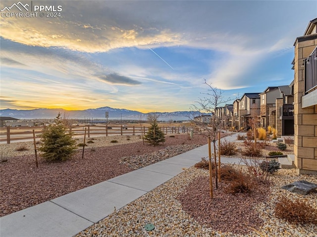 yard at dusk featuring a mountain view