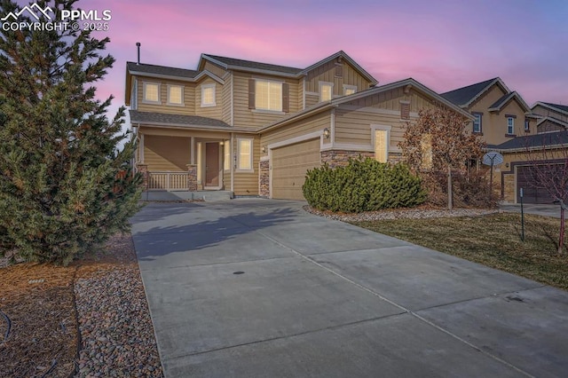 view of front of home with covered porch and a garage